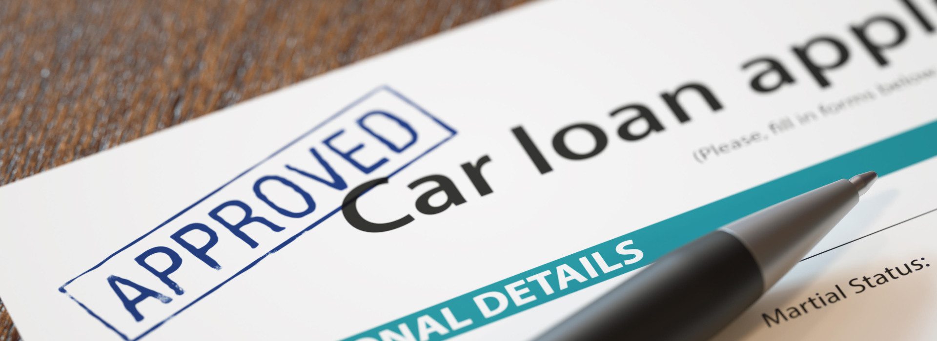 Approved car loan application with pen