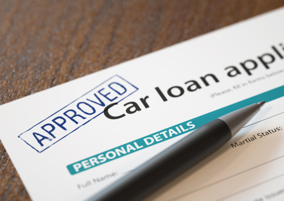Approved car loan application with pen