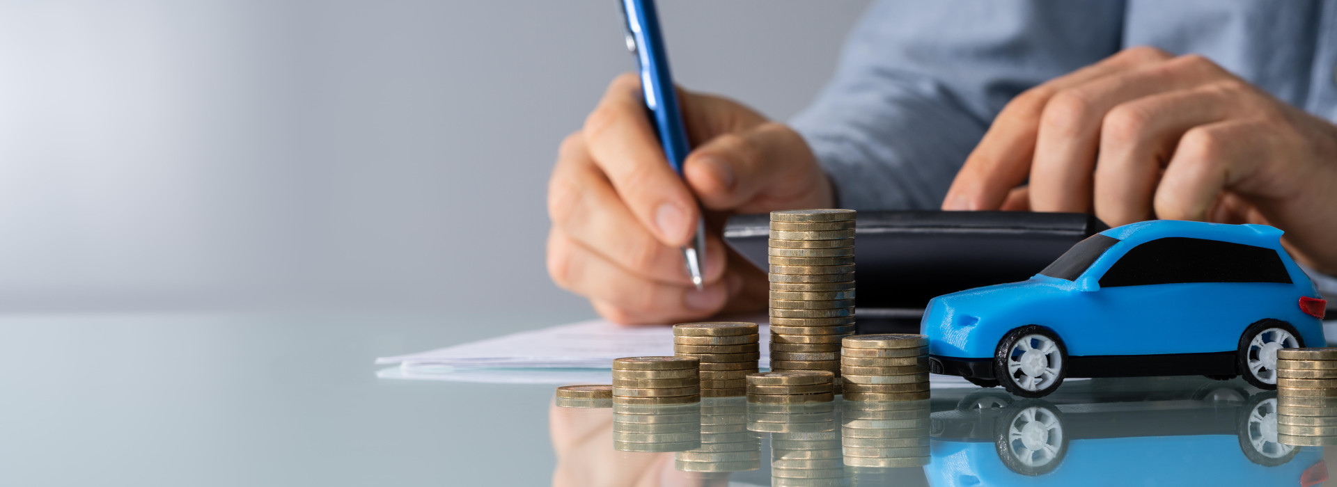 Car In Front Of Businessman Calculating Loan